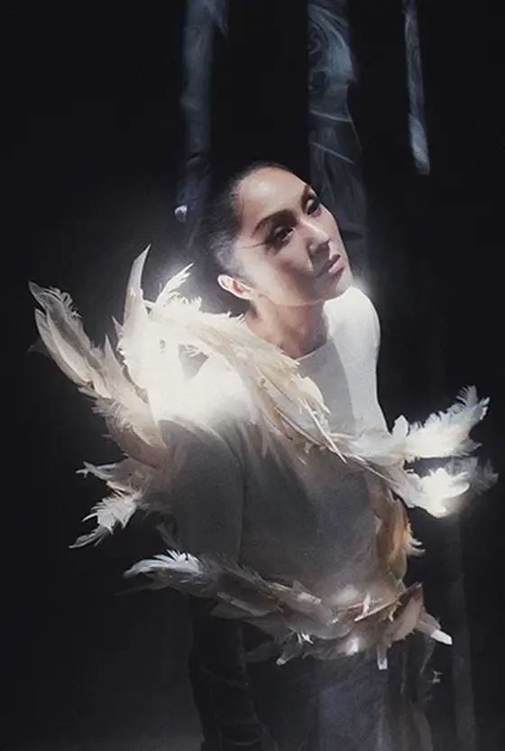 Miriam Yeung lit from behind, feathers catching the light
